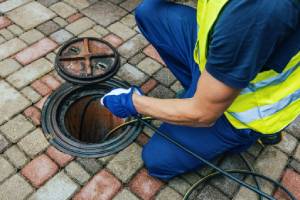 Plumbing technician cleaning a main line