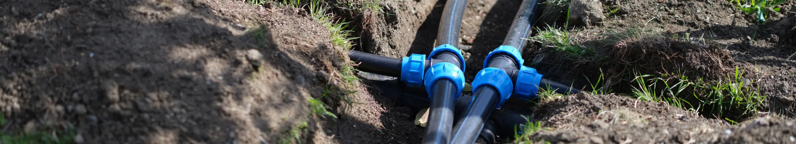 PVC plumbing pipes in the ground. Need help cleaning your sewer lines? RJ Plumbing Services can help with sewer line cleaning and repair services.